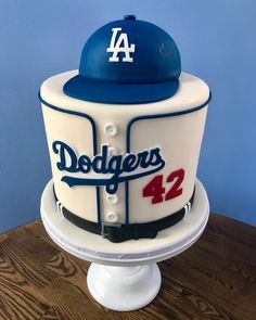 a dodgers baseball cake on top of a wooden table