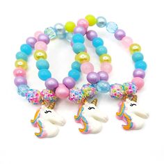 These adorable stretchy bracelets are the perfect favor for your little one's unicorn themed party! Each bracelet features a resin rainbow unicorn charm, resin rhinestone beads and an assortment of bright pastel rainbow 10mm acrylic beads strung with durable stretch floss cord. Each bracelet will arrive individually packaged in organza bags. Select the size and number of bracelets needed from the drop down menus. Please message me if you have any questions. Exact shade and bead styles will vary. Rainbow Novelty Jewelry For Birthday, Plastic Bead Jewelry For Birthday, Plastic Round Beads Jewelry For Birthday, Playful Rainbow Beaded Bracelets For Birthday, Playful Rainbow Jewelry For Birthday, Multicolor Unicorn Print Jewelry For Gift, Novelty Colorful Beads Jewelry For Birthday, Playful Jewelry With Colorful Beads For Party Favors, Plastic Beaded Jewelry For Birthday