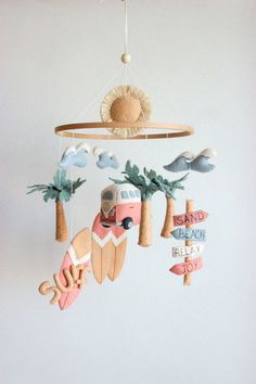 a mobile that is hanging from the ceiling with surfboards and palm trees on it