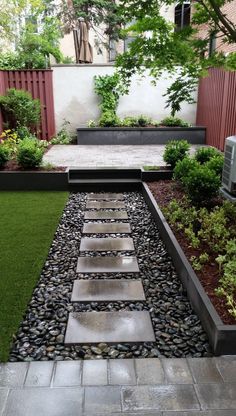 an outdoor garden with grass and stepping stones