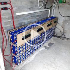 the inside of a building with many wires and electrical equipment in it, including an electric box