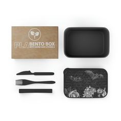 the bento box is packed with utensils and a black plastic tray that has flowers on it