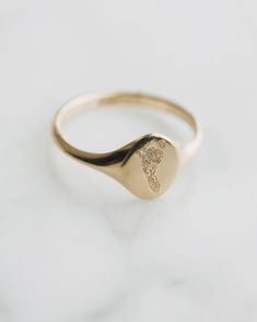 Graphic engraving Is the perfect way to incorporate a finger print, foot print, logo, or family crest. We believe your jewelry should tell your unique story and these engravings are no exception! Minimalist Recycled Gold Signet Ring For Anniversary, Minimalist Recycled Gold Engraved Ring, Oval Stamped 14k Gold Signet Ring, Minimalist Stamped Yellow Gold Engraved Ring, Minimalist Yellow Gold Stamped Engraved Ring, Minimalist Yellow Gold Engraved Stamped Ring, Minimalist Wedding Signet Ring With Engraving Option, Heirloom Style Signet Ring For Promise, Oval 14k Gold Stamped Signet Ring