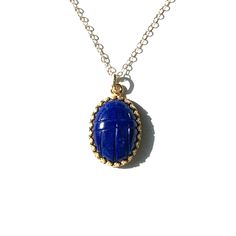 "Luxurious lapis lazuli scarab pendant necklace is a great gift for the self, or a loved one. This deep blue semi precious stone was hand cut and mounted in a gold filled crown bezel, then strung on a cable chain with spring clasp. Scarabs are considered to signify new beginnings and good luck. Pendant is 23mm by 14.5mm. Chain is 18\" long. We gift box all our jewelry. Need your gift wrapped and a short note? Leave a message to Carol at checkout for this complimentary service. International shop Scarab Pendant, Scarab Bracelet, Art Nouveau Antiques, Gold And Silver Rings, Semi Precious Stone, Chain Choker, Handmade Necklace, Gold Filled Jewelry, Cable Chain