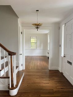 an empty house with wood floors and white walls