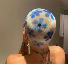 a woman with blue flowers painted on her back