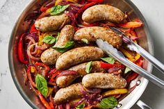 sausages and peppers in a pan with a fork