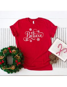 "Believe Shirt, Christmas Shirt, Christmas Believe Tee, Believe T-Shirt, Believe Shirt Gift, Believe TShirt,Believe Red,Merry Christmas Shirt ☀️☀️☀️☀️☀️ Everything in our shop is hand crafted and made to order. If you want different color or size contact me! If you would like something custom made to fit your personal style please message me and I will do everything to get you that something special. ---How To Order--- ⭐️Please, check and review all photos ⭐️Choose your t-shirt size and color ⭐️ Season Decorations, Christmas Believe, Dinosaur Gifts, Merry Christmas Shirts, Birthday Party Shirt, Dinosaur Birthday Party, Custom Printed Shirts, Grinch Christmas, Decorations Christmas