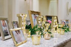 a table topped with pictures and candles on top of it