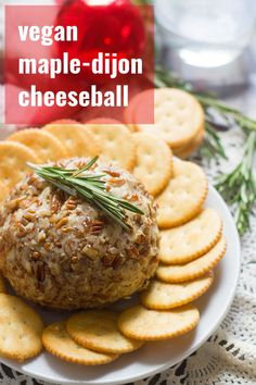 vegan maple - dijon cheeseball on a plate with crackers