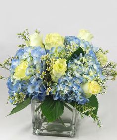 a vase filled with blue and yellow flowers