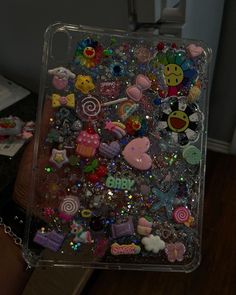 a clear case filled with lots of different types of buttons