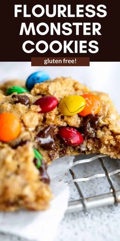 a cookie with m & m's on top and the words flourless monster cookies written