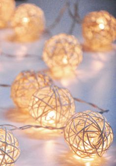 string lights with white balls on them sitting on a table