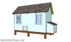 a small blue house with a brown roof