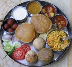 a metal plate topped with different types of food