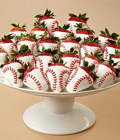 a platter filled with baseball and strawberry covered strawberries