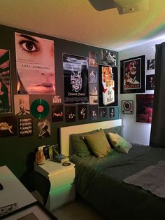 a bedroom with posters on the wall and a bed