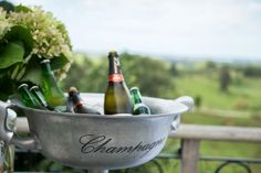 two bottles of champagne are in a silver bowl