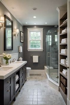 a large bathroom with two sinks and a walk in shower