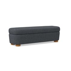 a grey bench with wooden legs and an upholstered foot rest on the bottom