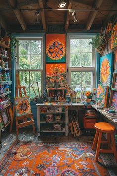 an artist's studio with lots of paintings and art supplies on the desks