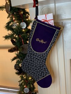 a christmas stocking hanging from the side of a door next to a decorated tree