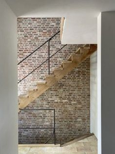 an empty room with brick walls and stairs