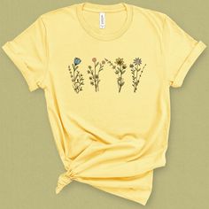 You'll channel your inner wild heart in this wildflower graphic tee, and feel warm sunny vibes. DETAILS This super soft and comfortable graphic t-shirt is made of 49% to 100% combed and ring-spun cotton. Check the size card for specific fabrications per color. I picked this t-shirt for its clean crew neckline, and contoured classic cut, that shoes our shape while not being too tight . I believe in social and environment responsibility. This t-shirt is fairly produced, uses eco friendly inks and Botanical Tshirt, Sunny Vibes, Tshirt Printing Design, Rose T Shirt, Wild Heart, Flower Graphic, Summer Gift, Spring Shirts, Wild Hearts