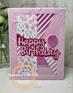 a pink birthday card with white flowers in the background