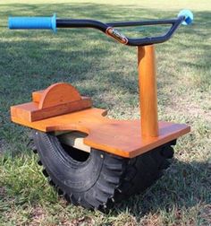 a small wooden scooter sitting in the grass