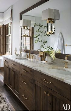 a large bathroom with two sinks and a bathtub in the middle of the room