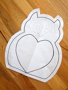 an owl cut out on the floor with paper