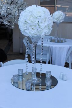 the centerpieces are adorned with crystal beads and white flowers