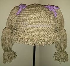 a straw hat with purple bows on the front and back of it's head