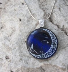 This is a pretty pendant created on a sparkling deep blue dichroic glass that has burgundy highlights,creating a striking backdrop for the white moon image. The enamel moon and stars are permanently fused to the glass and will never wear off. This larger pendant measures approximately 1.3"(3.4cm) in diameter,and is securely attached to a silver plated bail. The adjustable 16"-18" black cord is included. If you would prefer a silver plated snake chain. just let me know. Each purchase arrives in a pretty organza pouch. All of my jewelry is created in my home studio. Thanks for looking! Items are shipped via Canada Post letter mail. If you would like to purchase tracking, please make this selection at checkout. Burgundy Highlights, Fusing Glas, Fused Glass Necklace, White Moon, Pretty Pendant, Securely Attached, Night Blue, Dichroic Glass, Moon Pendant