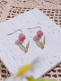 Introducing our exquisite collection of resin tulip drop earrings, a delightful fusion of elegance and charm. These earrings are meticulously crafted to capture the essence of delicate tulip blossoms, making them a perfect accessory for any occasion. With a drop height of approximately 1.1 inches, these earrings gracefully dangle from your ears, creating an eye-catching movement that enhances your every gesture. The total height of 1.5 inches ensures that they make a subtle statement without ove Elegant Resin Flower Earrings, Elegant Resin Flower-shaped Earrings, Elegant Resin Earrings With Pressed Flowers, Elegant Resin Flower Shaped Earrings, Elegant Pressed Flower Resin Earrings, Elegant Resin Birth Flower Earrings, Elegant Pressed Flowers Earrings For Mother's Day, Tulip Earrings, Multicolor Earrings