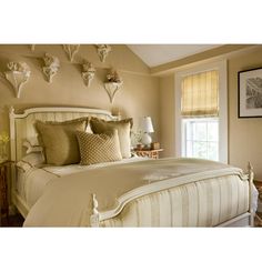 a large bed sitting in a bedroom next to a window