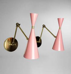 three pink lamps hanging from the ceiling