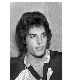 a black and white photo of a man with curly hair