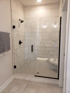 a walk in shower sitting inside of a bathroom