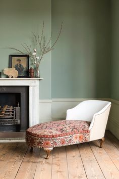 a white chair sitting in front of a fire place