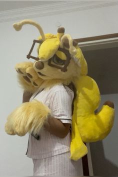 a person in a costume holding a stuffed animal