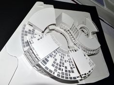 a paper model of a circular building on top of a table