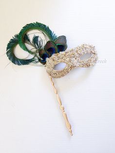 With the freedom to expose your true identity effortlessly, this fun and feminine masquerade mask on a stick is elegantly decorated with lace overlay & Rhinestones for a luxurious look. Perfect for any masquerade ball or costume party.   Gold Stick mask with feathers and rhinestones S H I P P I N G  -  Last minute masquerade mask shopping? Processed same day or within 24 hours.  1-2 day guaranteed delivery services offered, add items to cart and click on shipping tab for rates.  Pls leave a chec Venetian Masquerade Ball, Mask With Feathers, Masquerade Mask Women, Elegant Face Mask, Couples Masquerade Masks, Masquerade Ball Masks, Masquerade Ball Mask, Metal Mask, Feather Mask