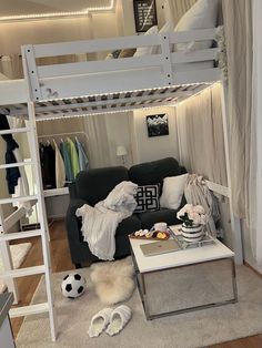 a white loft bed sitting next to a couch in a living room under a ladder