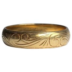 The 18carat gold band has fine scroll engraving and either side of the band there is a fine line framing the engraving. Ring Size: P 1/2 or 7 3/4 Band Width: 5mm Weight: 4.5g Art Deco Men’s Wedding Ring, Victorian Gold Engraved Ring With Decorative Band, Victorian Gold Engraved Etched Ring, Victorian Gold Etched Engraved Ring, Victorian Yellow Gold Etched Rings, Victorian Etched Gold Engraved Ring, Victorian Etched Yellow Gold Rings, Classic Engraved Band As Gift, Classic Gold Engraved Ring