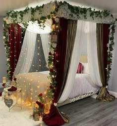 a canopy bed decorated with white and red flowers, greenery and lights on it