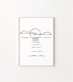 a black and white drawing of the sun over water