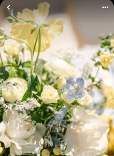 a vase filled with white and blue flowers